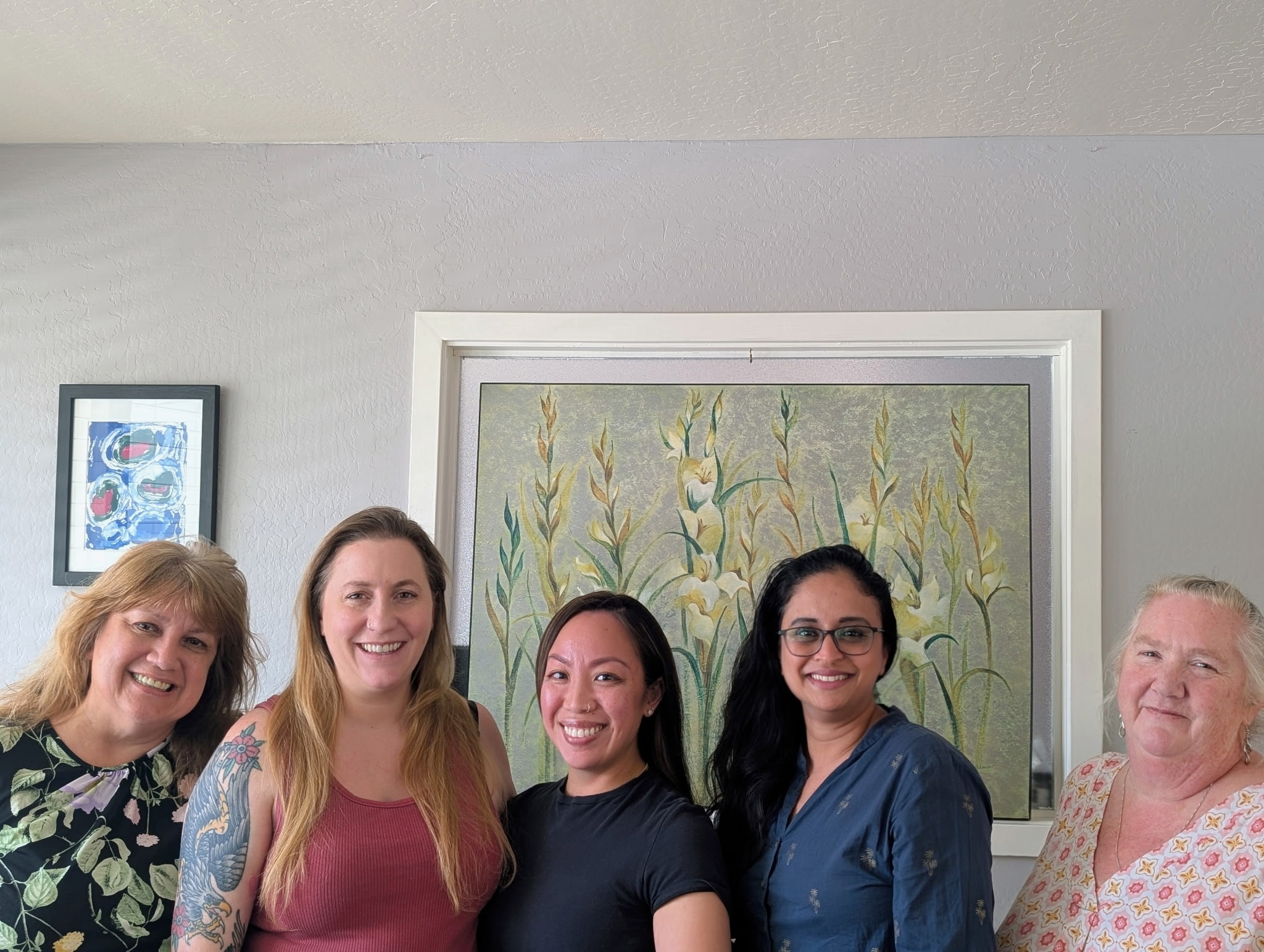 OFI staff and leadership team members smiling together.
