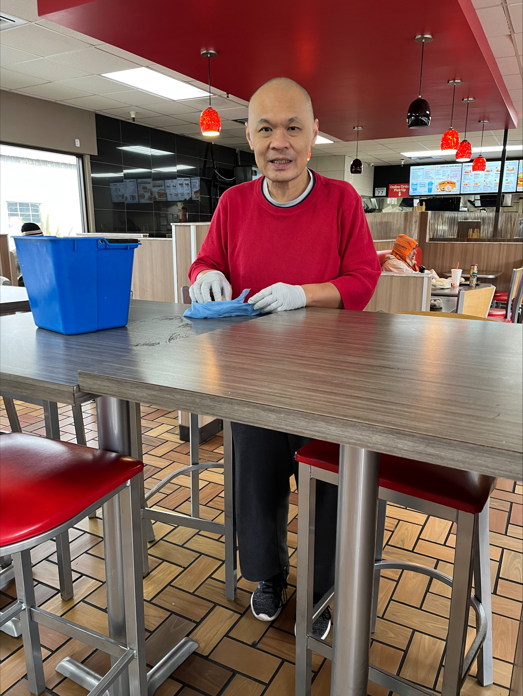 Man cleaaning tables at Burger King